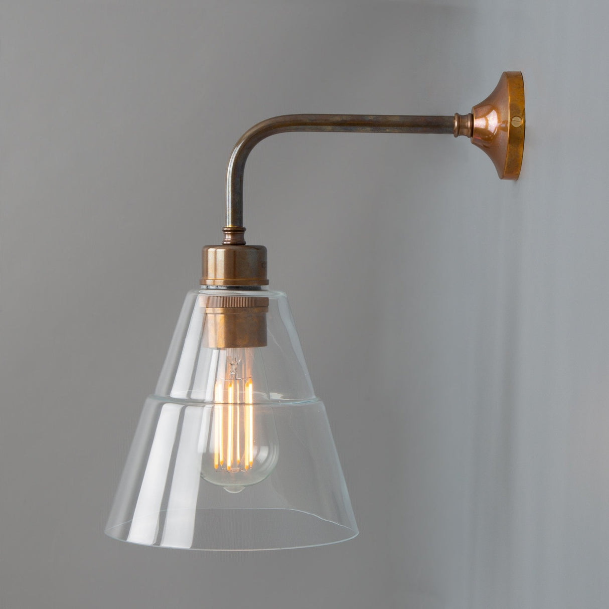 Lyx Antique Brass Wall Sconce with Clear Cone Glass Shade