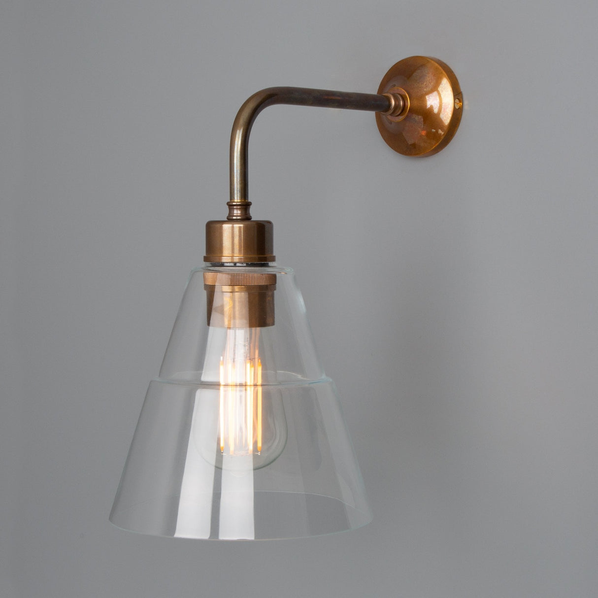 Lyx Antique Brass Wall Sconce with Clear Cone Glass Shade