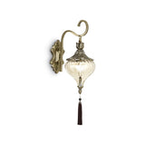 Moroccan Elegance Wall Sconce with Amber Glass and Ruby Tassel