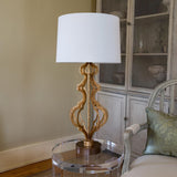 Elegant Octavia Table Lamp with Distressed Gold Frame and Cream Linen Shade on Dark Brown Base